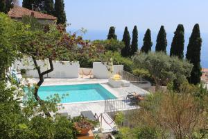 a pool in the middle of a yard with trees at Casa Cuseni, Patrimonio Culturale Immateriale UNESCO in Taormina