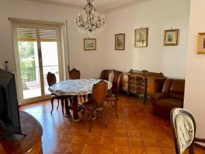 a dining room with a table and chairs and a television at Casa Roncaccia in Grottaferrata