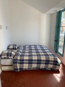 a bedroom with a bed with two pillows on it at Villa Jacqueline in La Seyne-sur-Mer