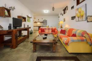 a living room with a couch and a coffee table at Apartamento Los 4 Nobles in Tinajo
