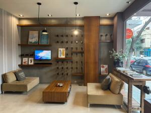 a living room with a couch and a coffee table at Sarum Hotel Design in Buenos Aires