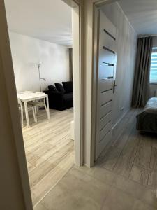 a room with a door and a living room at Flat4You IV in Poznań