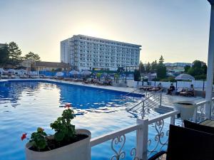 a large swimming pool with a building in the background at Aljoša Luxury Apartment in Jagodina