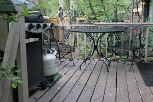 a patio with a table and chairs on a deck at Sunnyside Knoll- 10 studio in Estes Park +3 photos