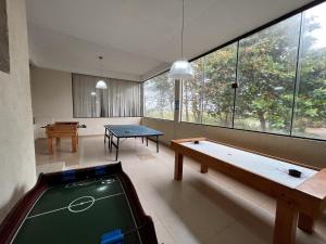 a room with a pool table and a table at Pousada do Albatroz in Cabo Frio