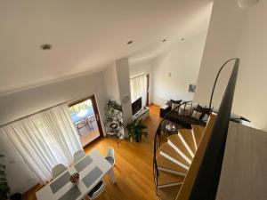 a living room with a staircase and a table and chairs at Apartments Flora 1 in Rab