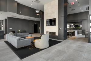 a living room with a couch and chairs and a fireplace at Fully Furnished Apt Near Millenium Park- 29 in Chicago