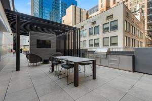 a patio with a table and chairs on a building at Fully Furnished Apt Near Millenium Park- 29 in Chicago