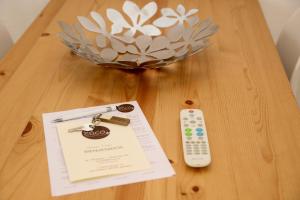 a table with a remote control and a certificate on it at Es Cucó in Cala Galdana