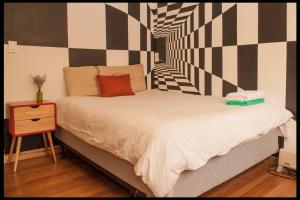 a bedroom with a large bed with a night stand at Artistic 2BR in NYC in New York