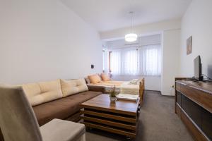 a living room with a couch and a table at Guesthouse Rose in Sarajevo