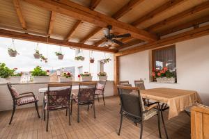 an outdoor patio with a table and chairs at Guesthouse Rose in Sarajevo
