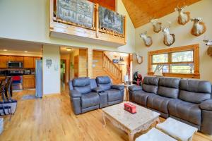a living room with a couch and a table at Piney Creek Cabin with Deck, Grill and Mountain Views! in Piney Creek