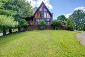 a house with a large yard in front of it at Piney Creek Cabin with Deck, Grill and Mountain Views! in Piney Creek