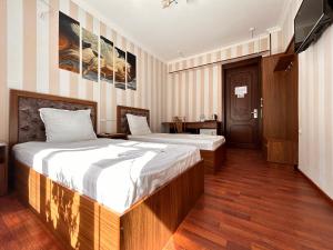 Кровать или кровати в номере Hotel Ishonch