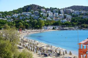 a beach with a bunch of umbrellas and a group of people at Best view in the Bay! in Athens