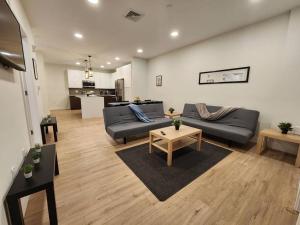 a living room with two couches and a table at Deluxe 2 Bedroom VIP to NYC in Union City