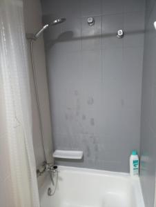 a shower in a bathroom with a shower curtain at Apartamento Parchís con piscina in Denia +55 photos