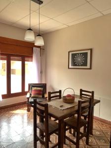 a dining room with a wooden table and chairs at Departamento VILLA NUEVA in Villa María