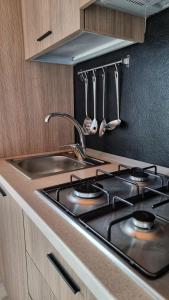 a kitchen with a sink and a stove with utensils at REST AND VIEW APARTMENT in Vercana +42 photos