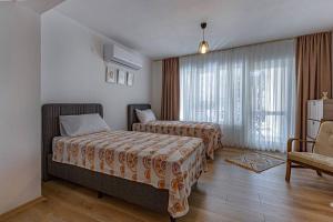 Postel nebo postele na pokoji v ubytování Güneş Villa Bahçe Katı