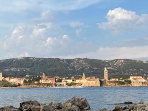a town on the shore of a body of water at Apartments Flora 2 in Rab