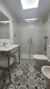 a bathroom with a shower and a sink and a toilet at LA MARINA in Torre del Mar