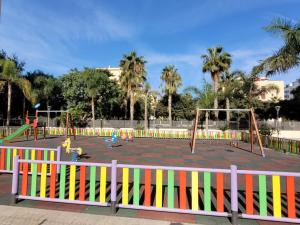 a park with a playground with swings at LA MARINA in Torre del Mar