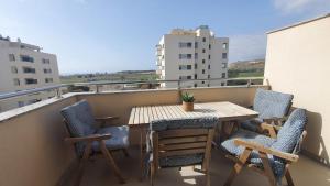 a table and chairs on a balcony with a view at LA MARINA in Torre del Mar