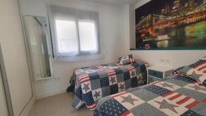 a bedroom with two beds and a window at LA MARINA in Torre del Mar +15 photos