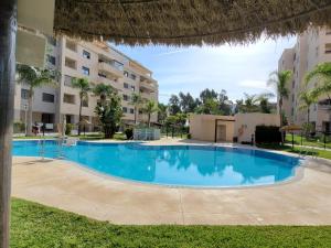 a large swimming pool in front of a building at LA MARINA in Torre del Mar +17 photos
