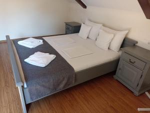a bedroom with a bed with two towels on it at Gasthof Clara in Sibiu