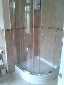 a shower with a glass door in a bathroom at The Caraneal in Plymouth