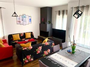 a living room with a couch and a table at VILLA ARMONIA GUEST HOUSE in Prinos