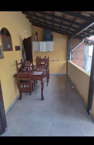 a dining room with a table and chairs in a building at casa temporada da Cris in Paraty