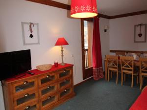 a living room with a tv on a dresser and a dining room at Appartement Lanslebourg-Mont-Cenis, 3 pièces, 6 personnes - FR-1-508-255 in Lanslebourg-Mont-Cenis