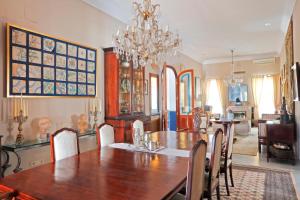 a dining room with a table and a chandelier at Villa Paula Valencia in Manises