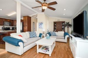 a living room with two couches and a flat screen tv at This Is It by Oak Island Accommodations in Oak Island