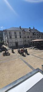a group of motorcycles parked in front of a large building at Villa Duchatel Appt 2/4 pers in Le Mont-Dore