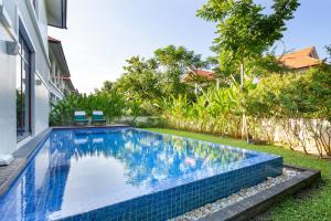 a swimming pool in the backyard of a house at Tropical Pool Villas Da Nang in Da Nang