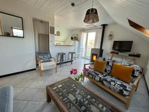 a living room with a couch and a table at Le Cosy Home Annecy in La Balme-de-Sillingy