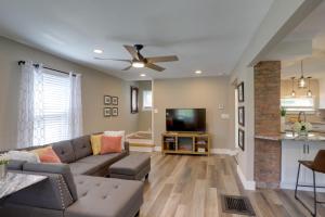 a living room with a couch and a flat screen tv at Welcoming Willoughby Home 1 Mi to Historic Dtwn in Willoughby