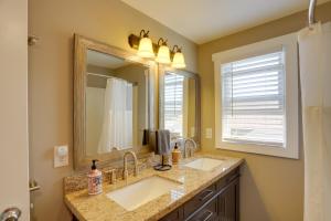 a bathroom with two sinks and a large mirror at Welcoming Willoughby Home 1 Mi to Historic Dtwn in Willoughby +20 photos