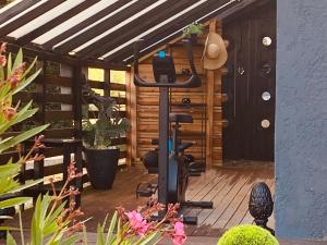 a patio with an exercise bike on a deck at Le Clos Romantic & Spa - Périgueux - Bassillac et Auberoche in Eyliac