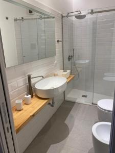 a white bathroom with a sink and a shower at Egregia Dimora in Catania +13 photos
