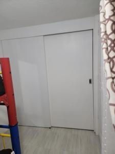 a white door in a room with a wooden floor at (6)Cuarto ideal para descansar. in Tlazcalancingo