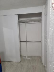 um quarto com paredes brancas e um armário com prateleiras em (6)Cuarto ideal para descansar. em Tlazcalancingo