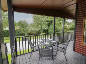 a patio with a table and chairs on a deck at Rose in Leominster