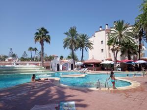 a pool at a resort with people playing in it at Estudio Caballo-Piscina in Denia