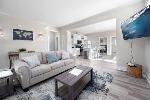 a living room with a couch and a table at Cozy Ranch New Build 3 bed 2 bath in Durham